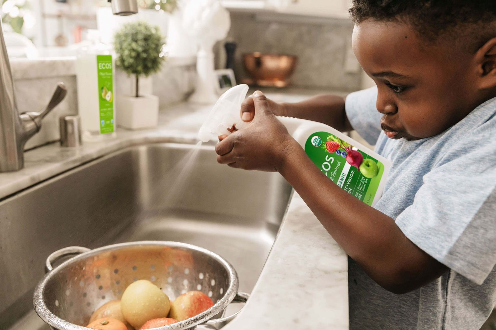 Kid Cleaning Apples With Organic Fruit and Veggie Wash